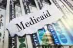 Medicaid newspaper headline on hundred dollar bills with US Capitol in Washington DC